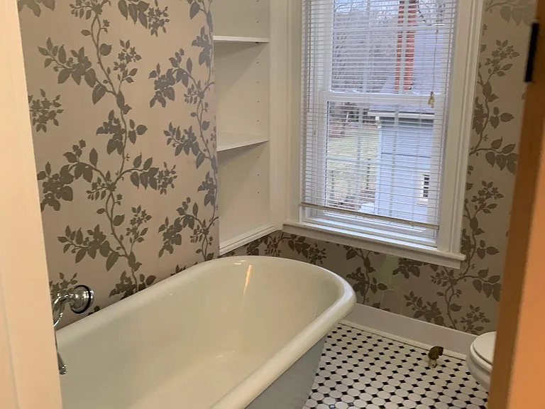 Built-in shelves for storage. Soaking claw-foot tub with handheld sprayer.