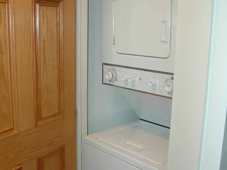 Stacked washer/dryer in unit