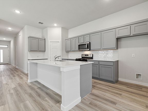 Kitchen in the Quartz home plan by Trophy Signature Homes - REPRESENTATIVE PHOTO