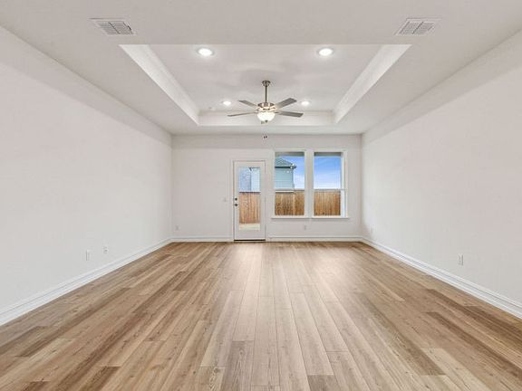 Bright gathering room with large windows real home pictured