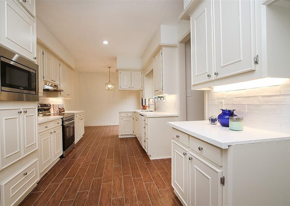 Beautifully updated kitchen with white subway tile backsplash and under counter lighting.