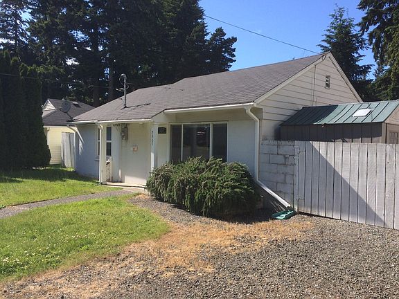 Storage shed on the right, beyond the gate/fence, behind the off street parking.