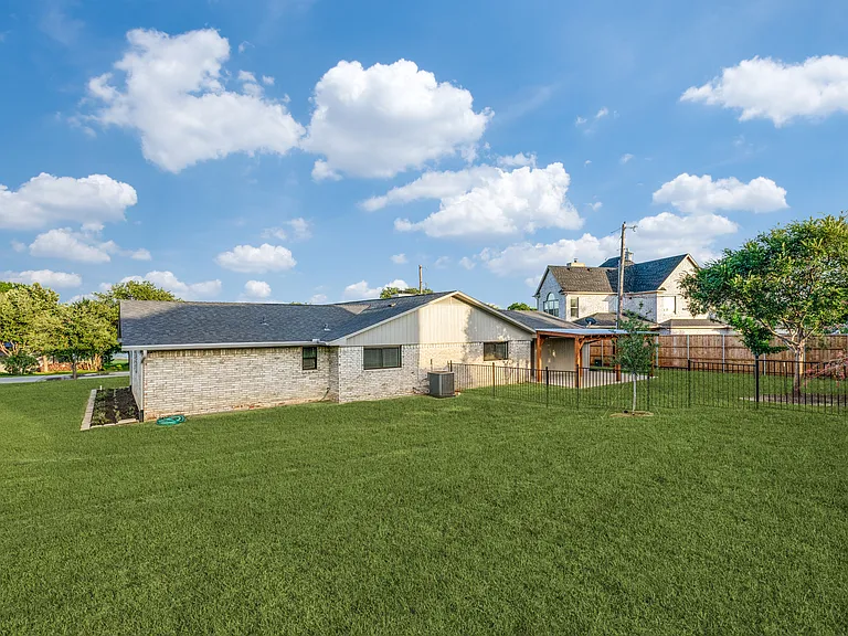 Large corner lot with a fenced in backyard area.