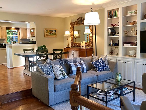 Entry opens into living area and steps up to dining room with open kitchen.