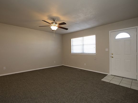 Spacious living area by front door.