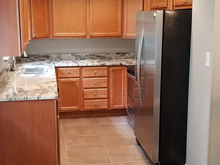 Upscale kitchen, granite countertops, stainless steel appliances, new flooring just added, view of back yard and river