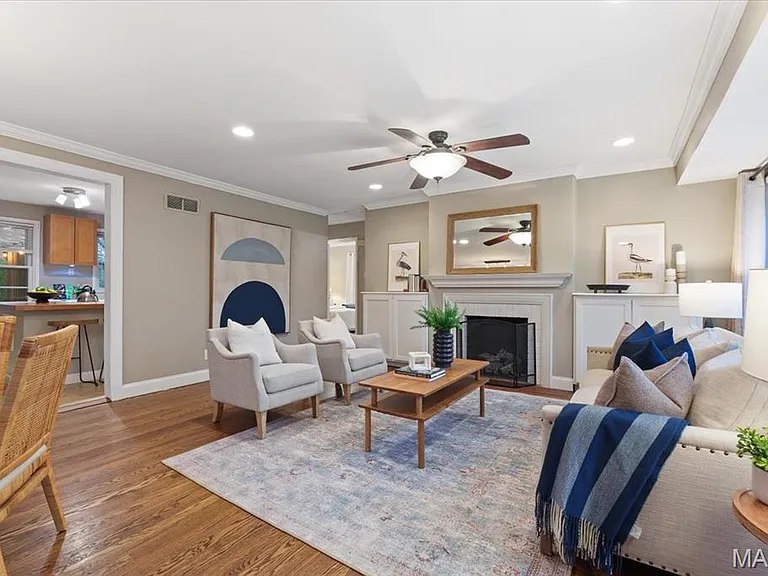 Living room with gas fireplace with built in book shelves.