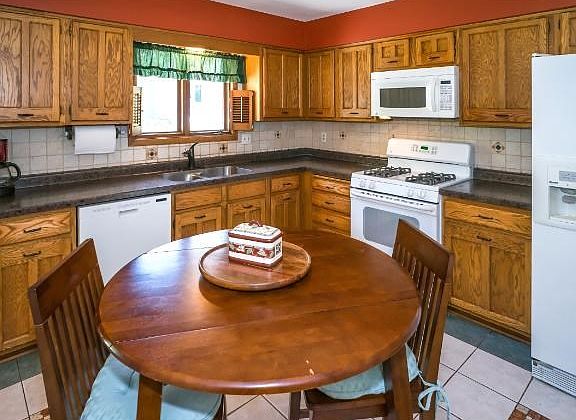 Gourmet kitchen with new high definition countertops, sink and faucets.