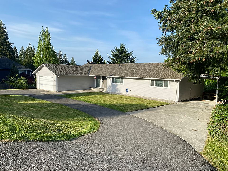 Front of the home with U-shaped driveway