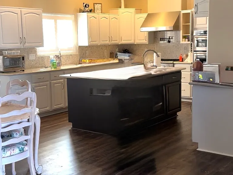 Large kitchen island has prep sink and lots of storage