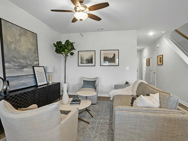 Spacious living room with ceiling fan