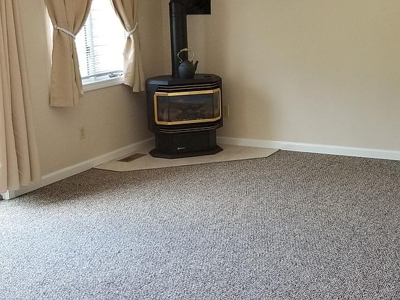 New carpeting and propane stove in livingroom