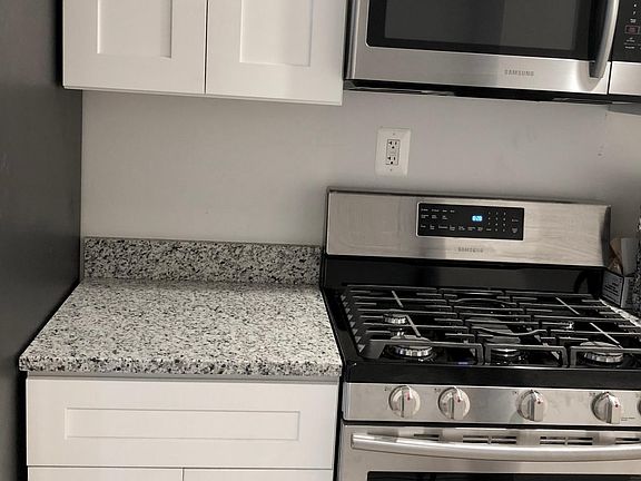 Close up of the cabinets and counters. Full gas range.