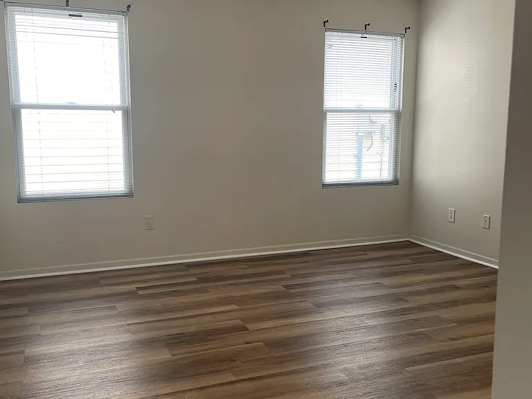 master bedroom with wood floor and ceiling fan