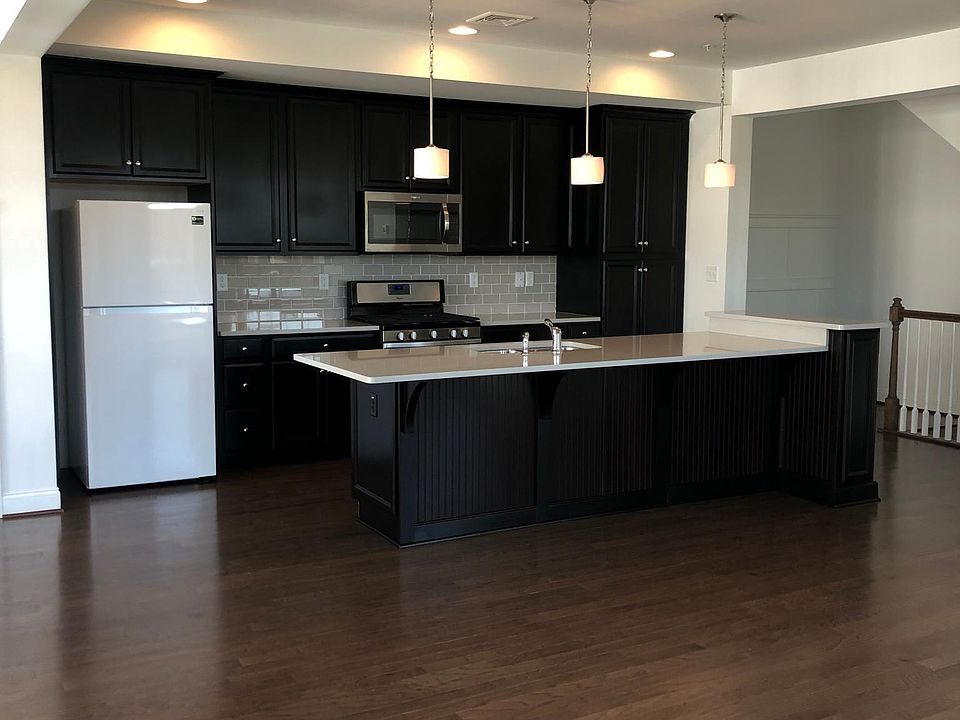 Kitchen, breakfast bar with open floor plan to family room - Fridge has recently been updated to stainless steel model