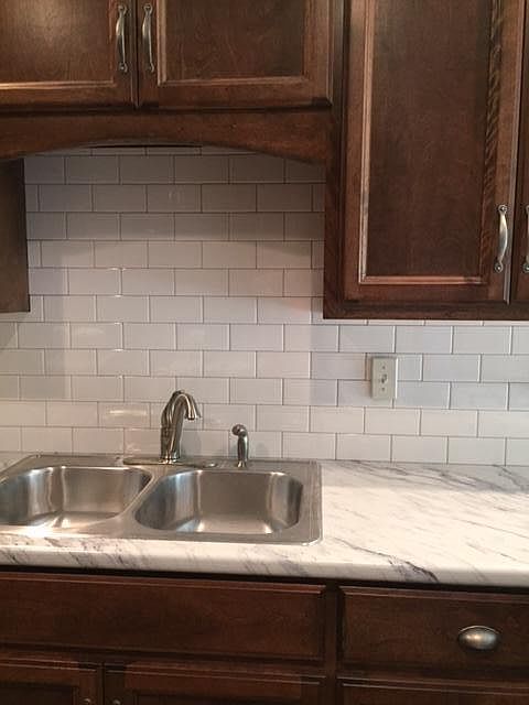Kitchen with tile backsplash and custom cabinets