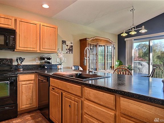Open and airy kitchen with hard surface countertops and plenty of cupboards!