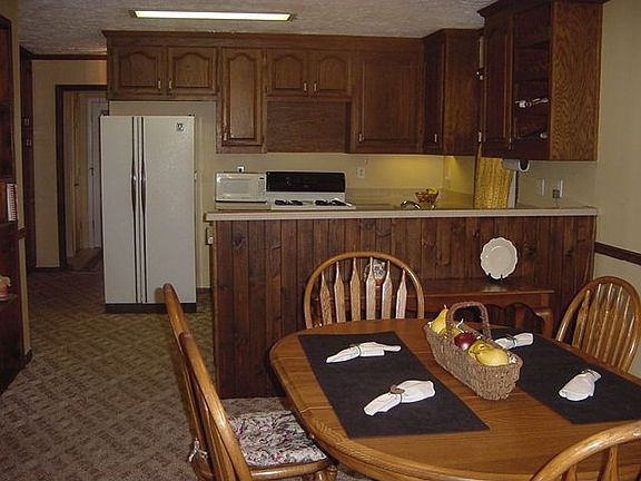 Dining area opens to kitchen and overlooks living room.