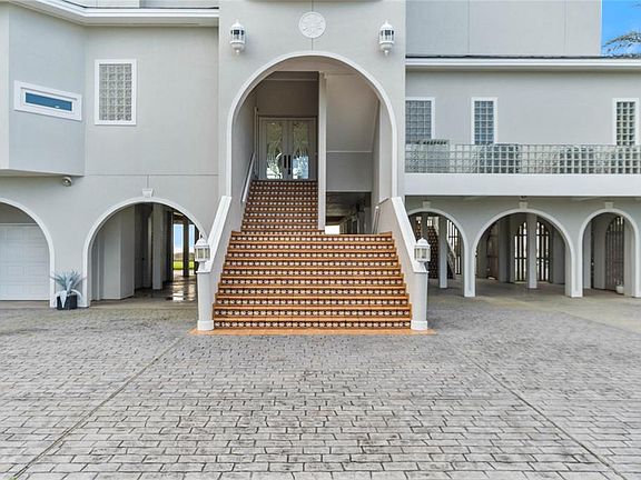 Enter this home from a beautiful custom-tiled staircase to an impeccable floor plan that was surely built to entertain.