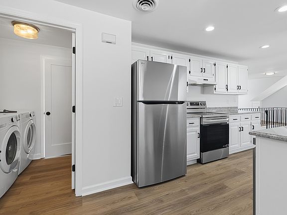 Kitchen with view of in unit laundry