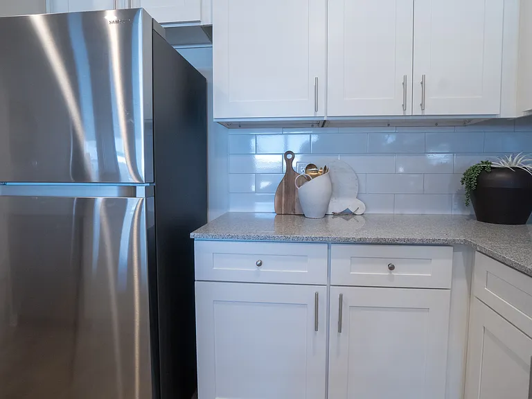 Kitchen nook showcasing ample storage/cabinet space and a stainless steel refrigerator.