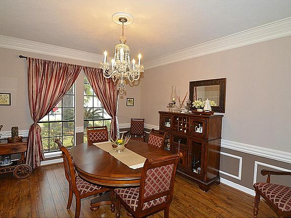 Formal Dining w/Beautiful Flooring, Double Crown Molding & Charirails. Spacious w/Room for Large Furniture