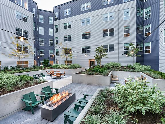 Relax in the meticulously landscaped courtyards offering lounge seating and a cozy fire table.