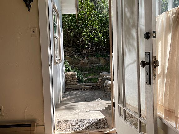 Nature enhanced with lots of river rock terracing surrounds the home.