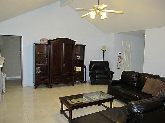 Enter through the foyer (right) and walk straight into the den. There is a coat closet on your right