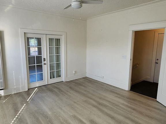 Livingroom from another Angle with French doors leading to 1st Bedroom