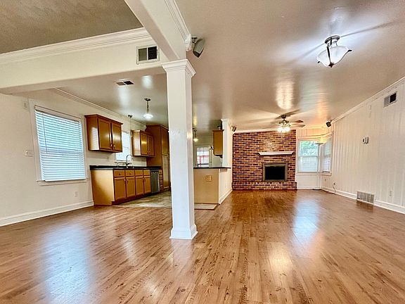 view upon entering: connected dinning, living, kitchen, and den