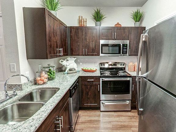 Apartments for Rent in Austin, TX Nolina Flats Kitchen With Stainless Steel Appliances, and Modern Dark Wood Cabinets