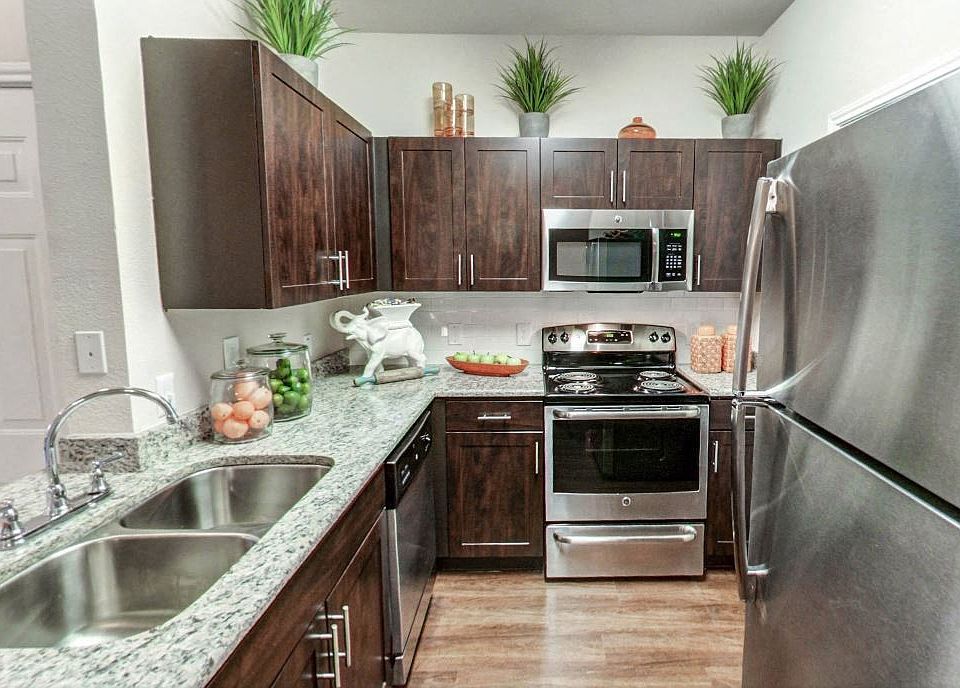 Apartments for Rent in Austin, TX Nolina Flats Kitchen With Stainless Steel Appliances, and Modern Dark Wood Cabinets