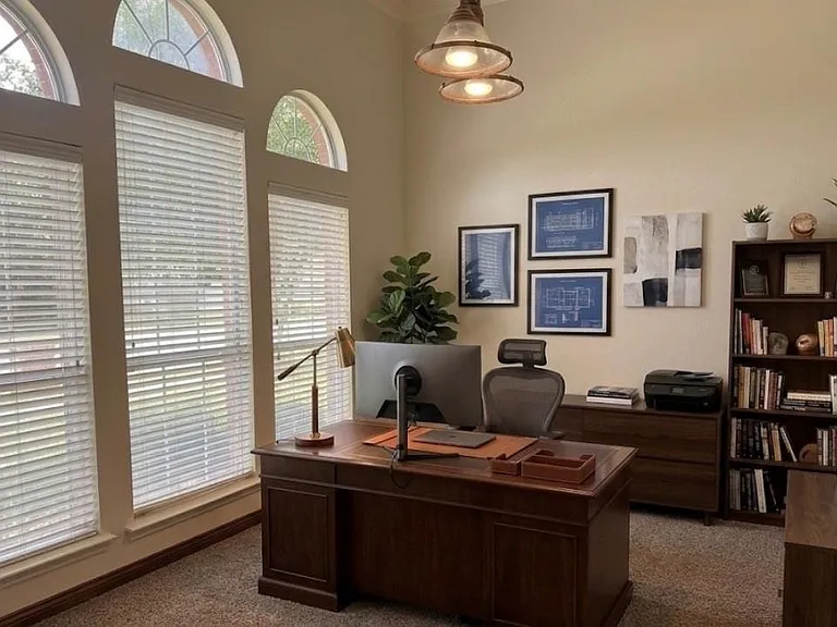 Virtual staging: Spacious room featuring vaulted ceilings and multiple windows with arched transom elements