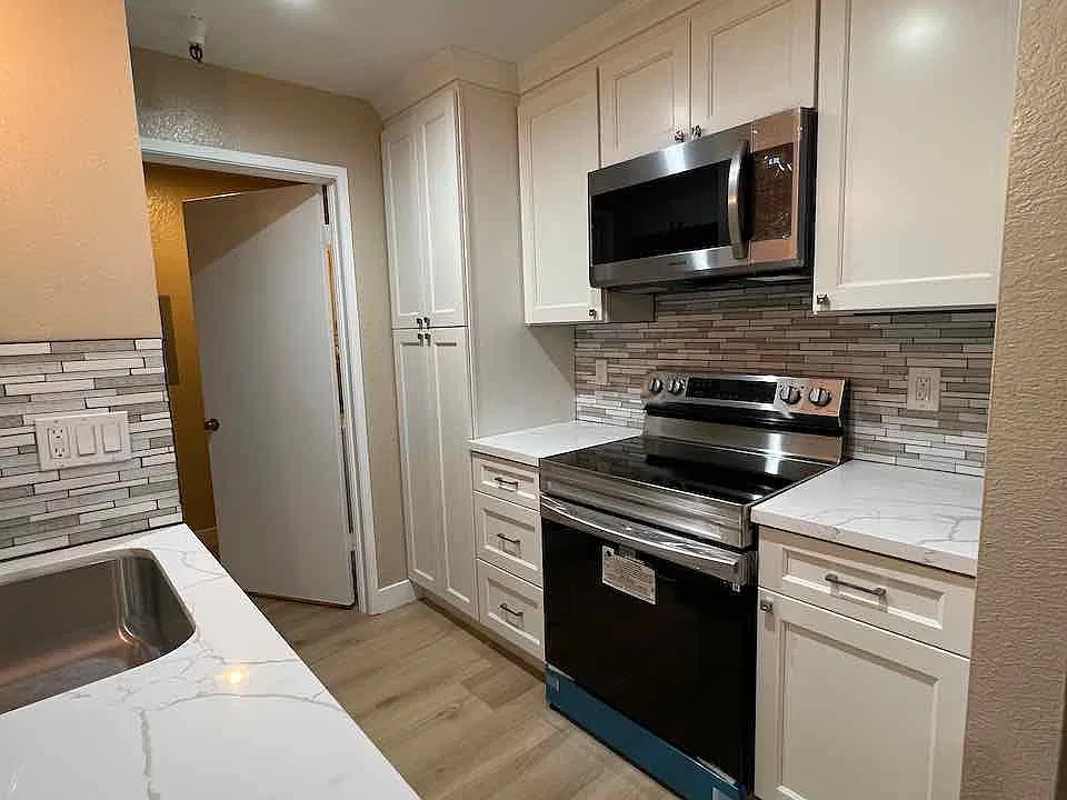New white cabinets with soft close doors and drawers, marble quartz counters