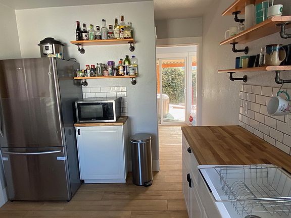 Kitchen to bright laundry room and new covered deck area.