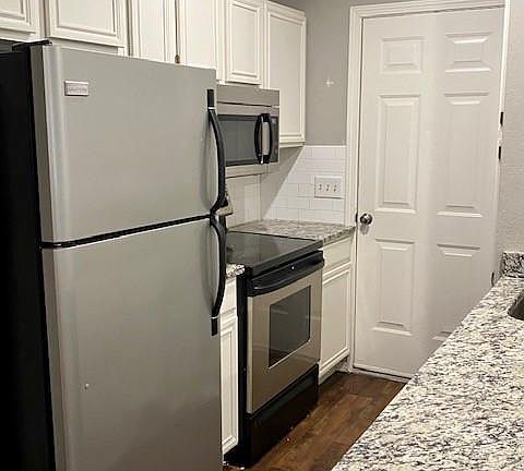 Kitchen has stainless steel appliances and double stainless-steel sinks.