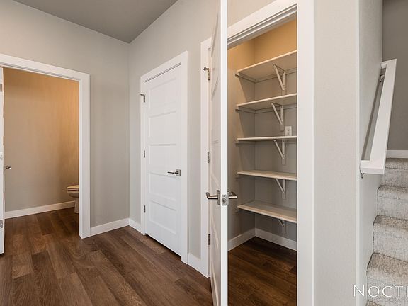 Off the entry way is 1/2 bath, storage space, and pantry. (Photo of another unit with similar finishes and quality.)