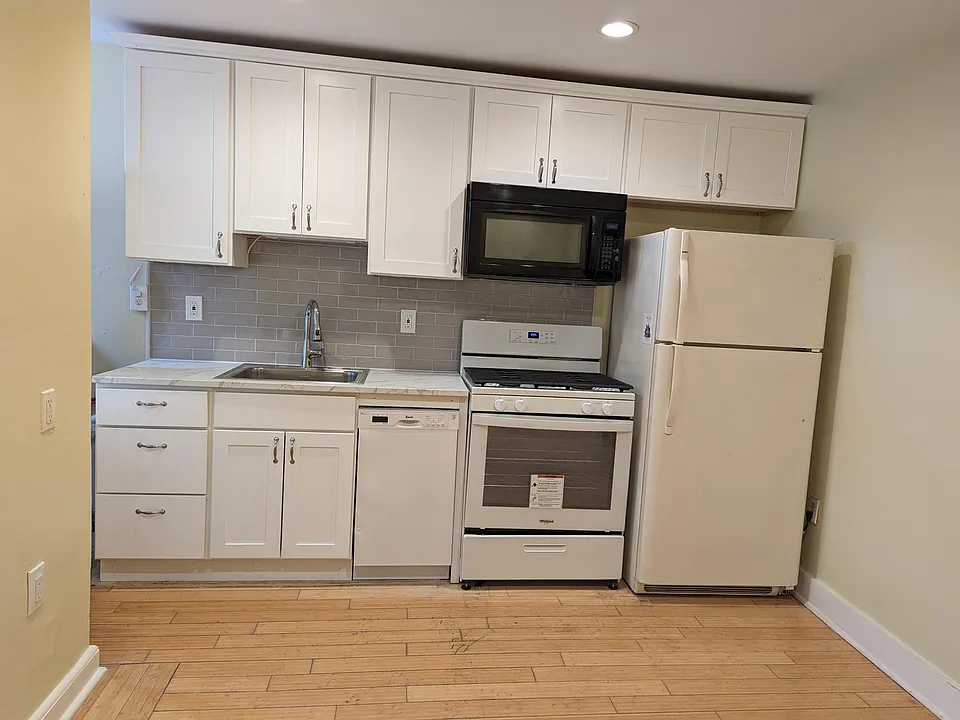 Kitchen with new cabinets, new stove and new dishwasher.