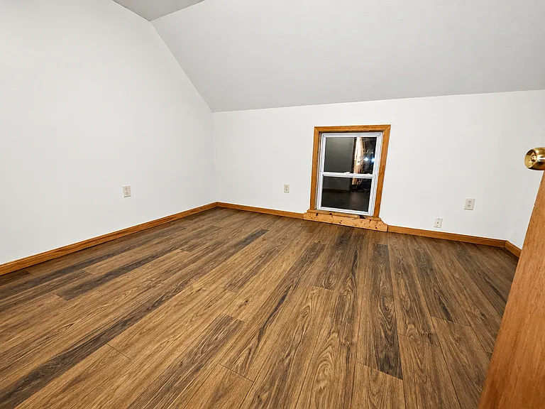 Second spacious bedroom with warm wood trim