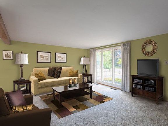 Living room features floor to ceiling windows that let the light shine in. Great-room concept with living room, dining room and kitchen all open to one another; keep the cook company!