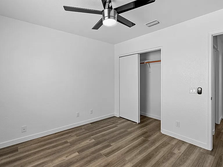 Bathroom 2; wooden closet doors. 
Outside the door, Bathroom 1 to the left, Bedroom 1 straight across. Living room to the right.