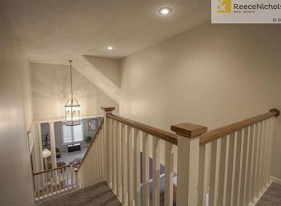 Stairs leading to three bedrooms with walk-in closets and two full baths.