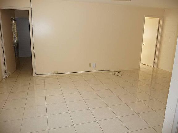 Bright tiled living area leading to both bedrooms