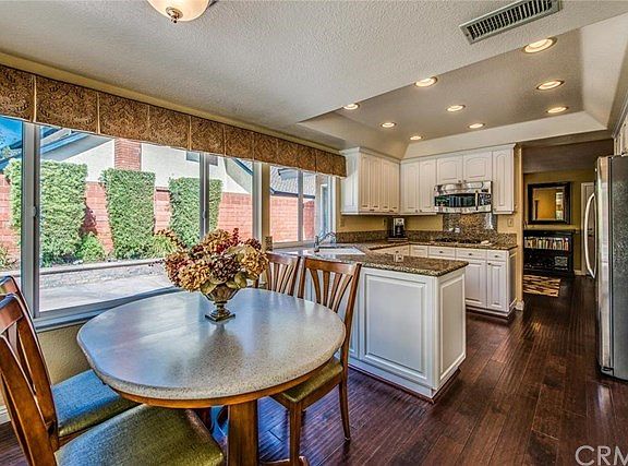 Open kitchen with granite counters and recessed lighting