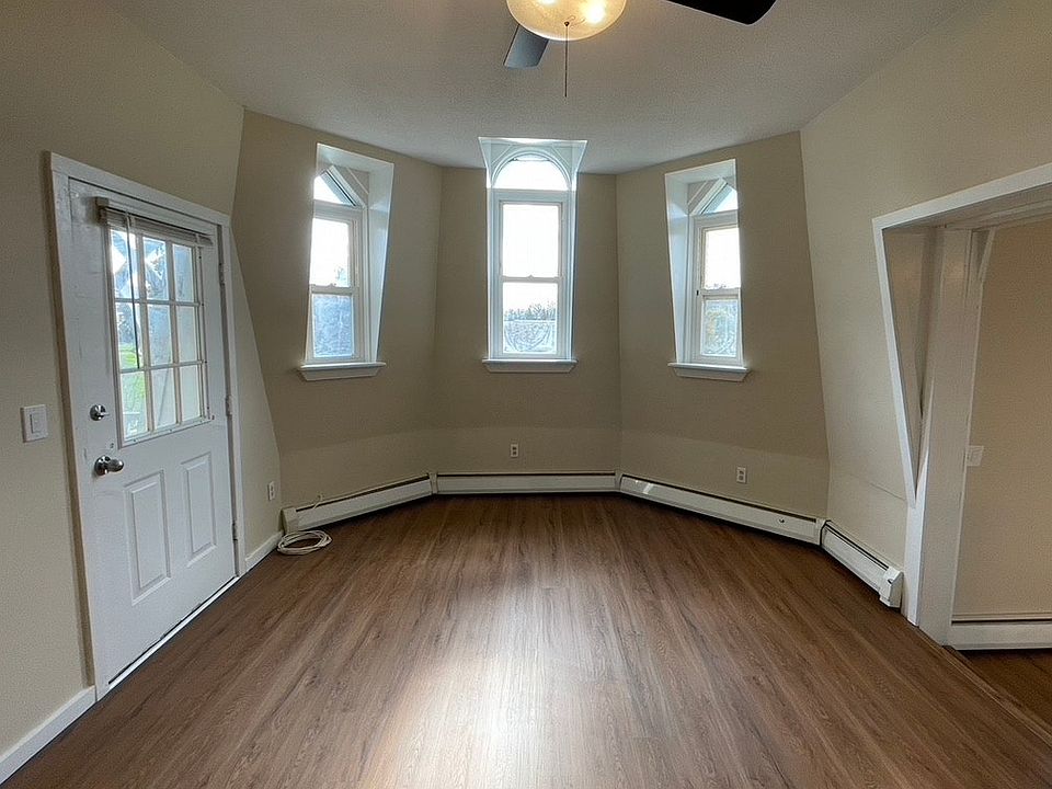 Three tall windows in the living room (Note: This photo is from the apartment next to it)