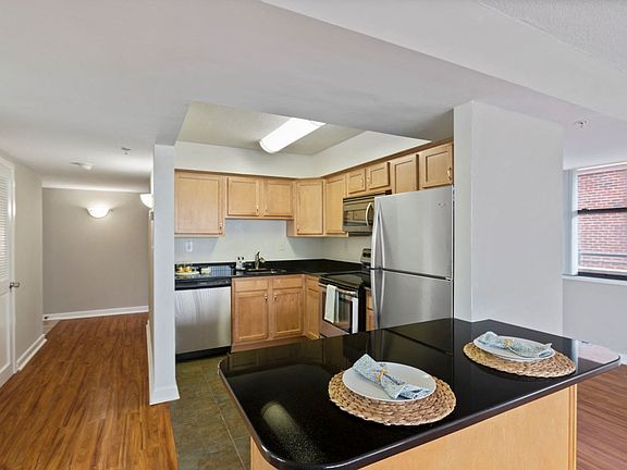 Two-bedroom apartment kitchen with stainless steel appliances and bar area