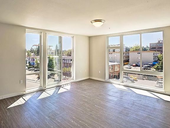 Spacious living room with floor to ceiling windows for lots of natural light
