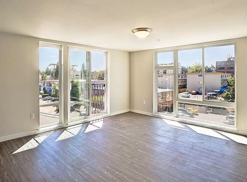 Spacious living room with floor to ceiling windows for lots of natural light