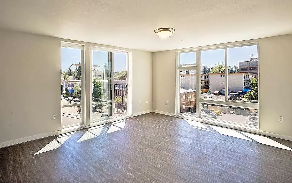 Spacious living room with floor to ceiling windows for lots of natural light - 12350 33rd Ave NE #401